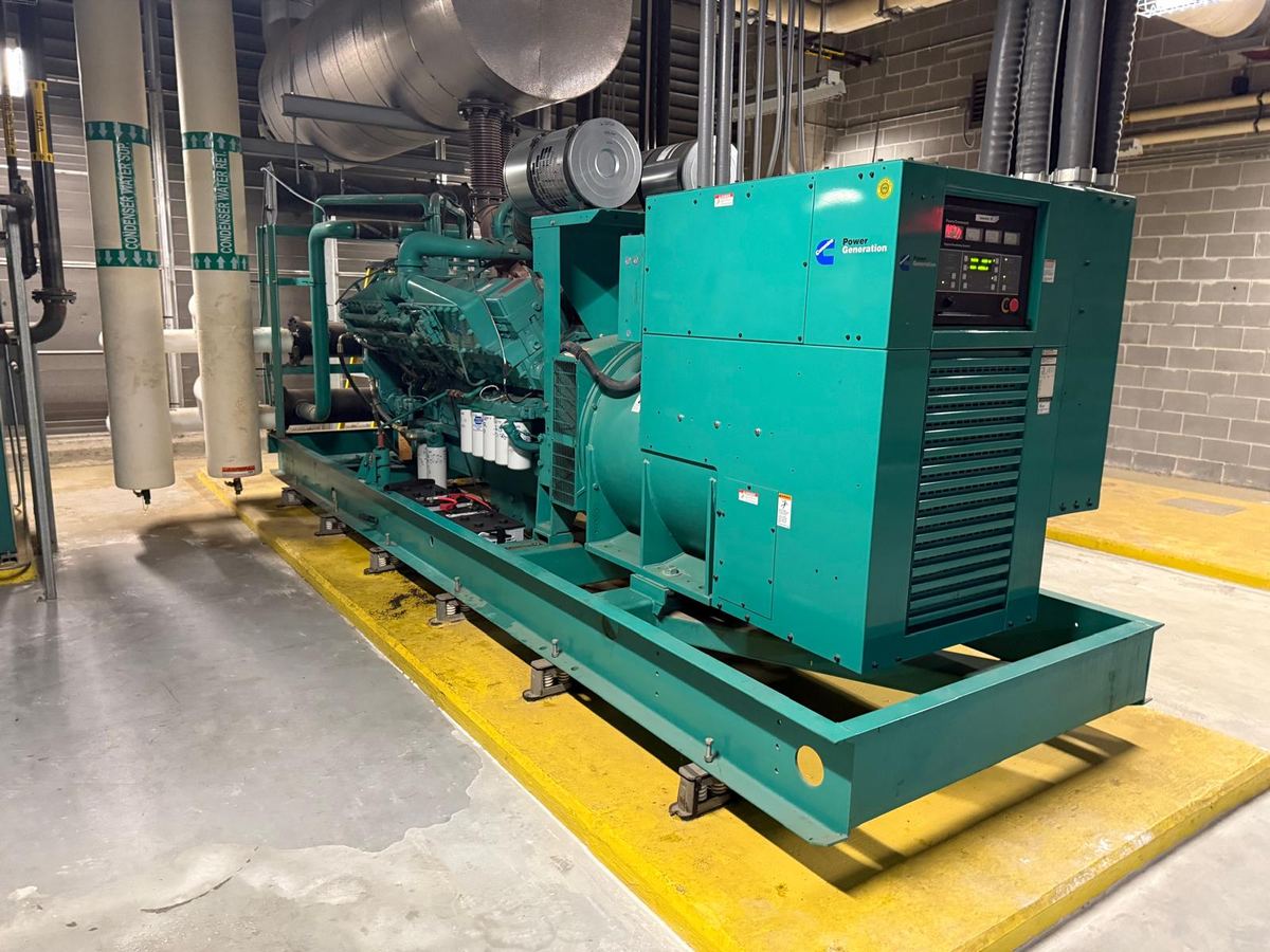 Standby generator set into position on its base in a plant room