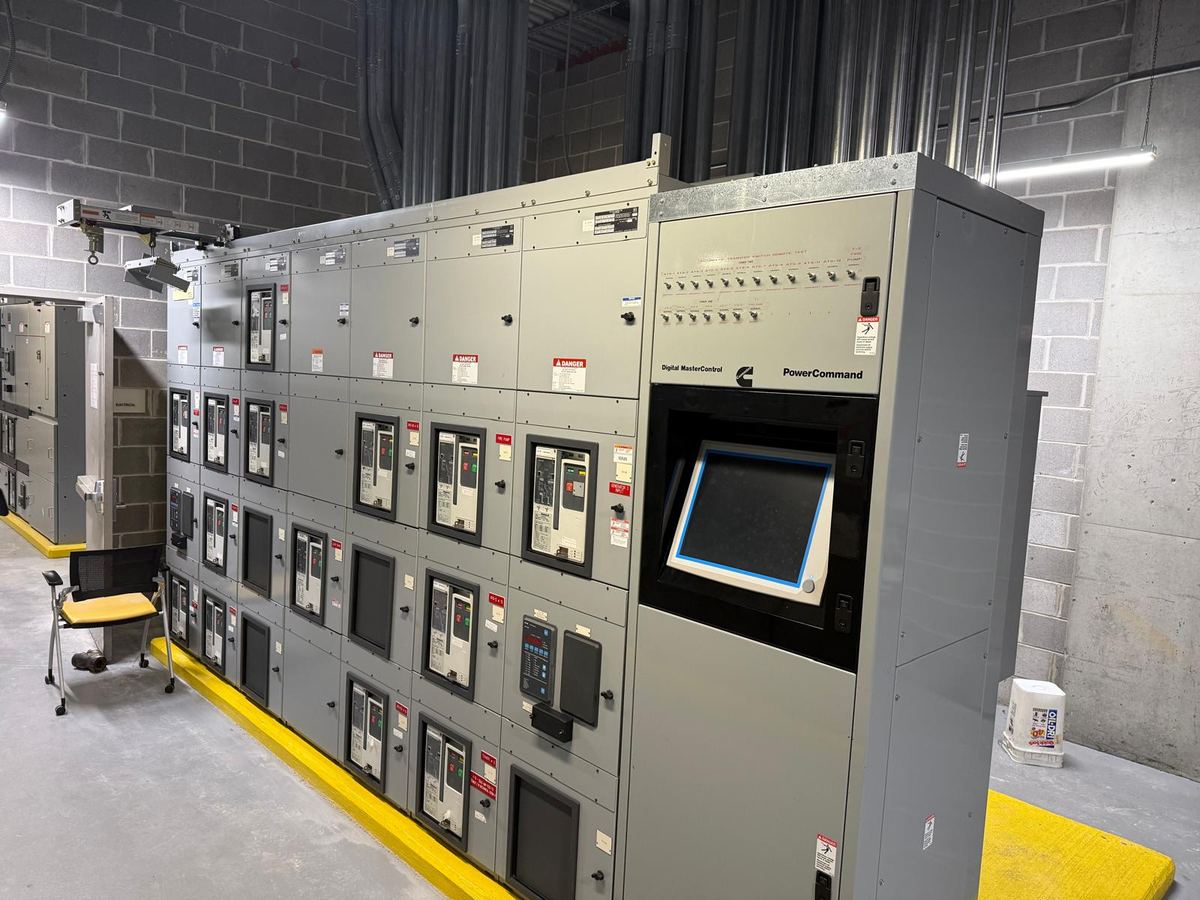 Row of electrical switchgear panels installed in a facility plant room
