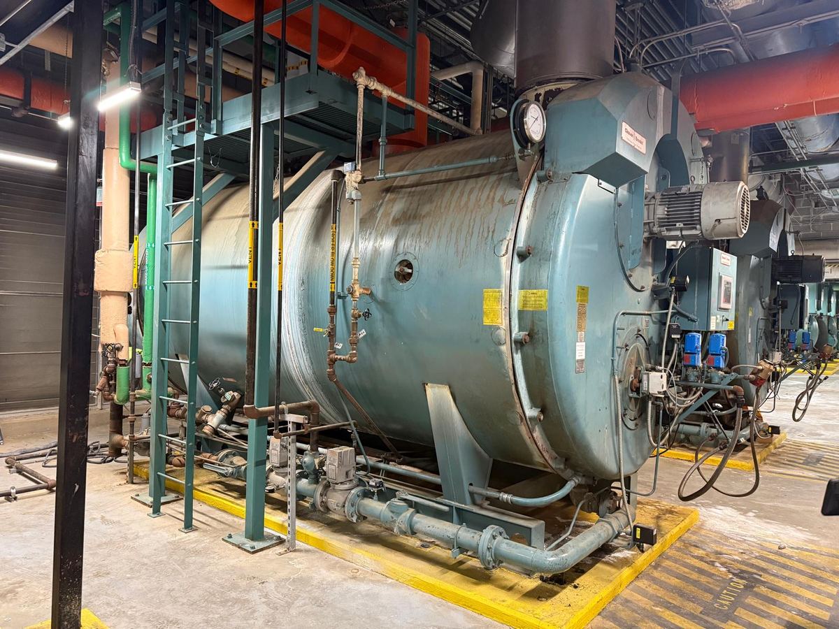 Large boiler vessel rigged into position in a mechanical plant room